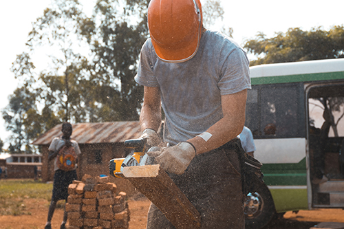 Image of a single worker in a foreign country providing aid