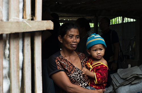 Image of a mother holding her child in a doorway